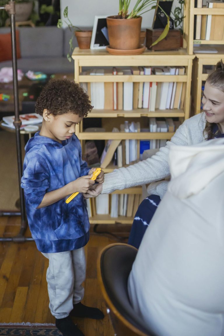 Mother giving toy to black son